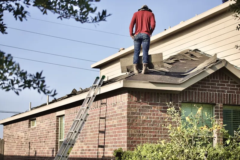 Professional roofer working on a residential roof in Marconi North